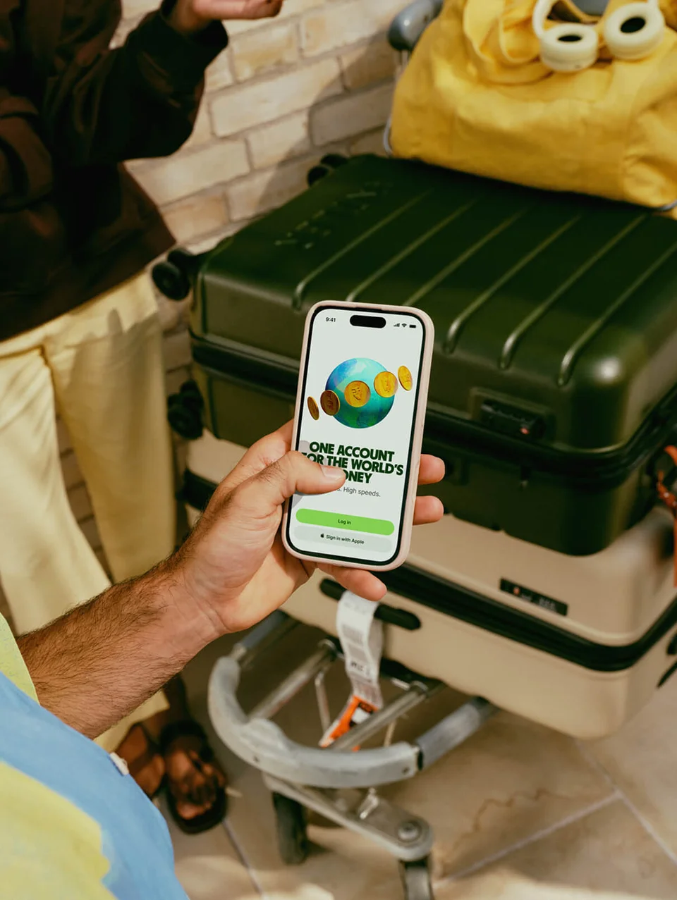 A person using the Wise app on their phone whilst at the airport.