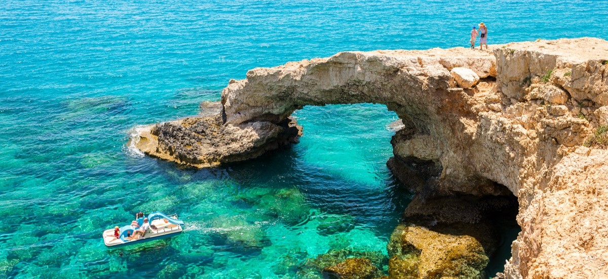 Tourists enjoying the clear waters and rocky coast of Cyprus