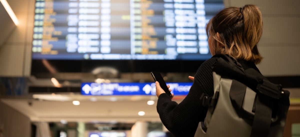 woman-checking-departures-at-airport