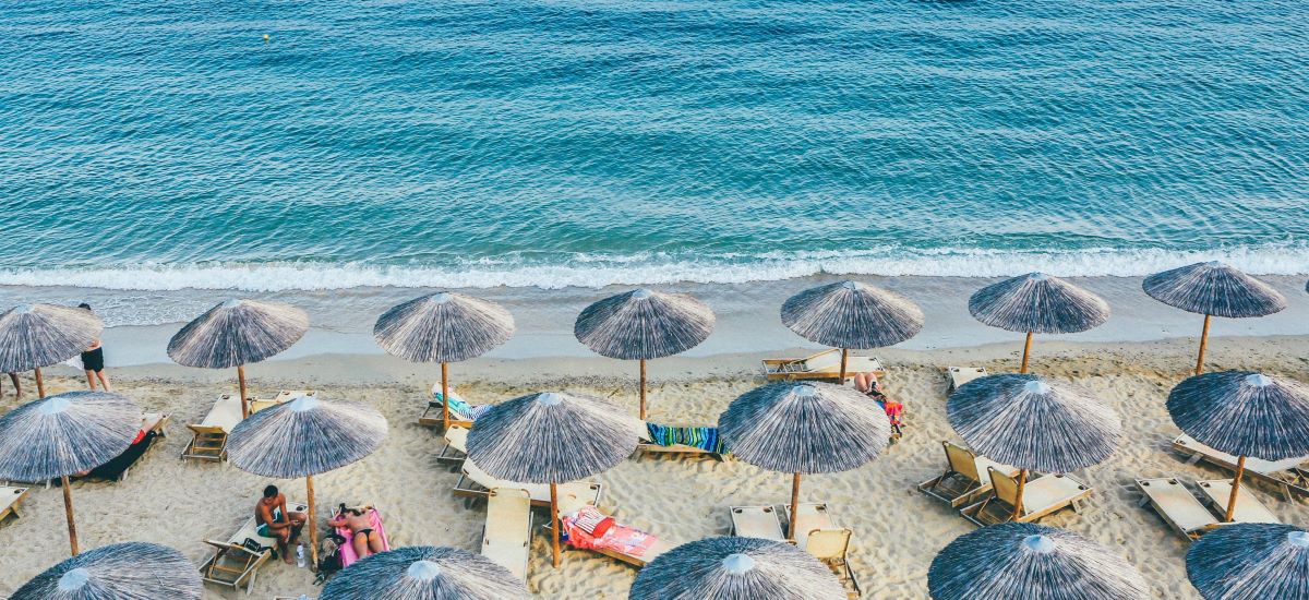 Greek beach full of umbrellas and beach chairs