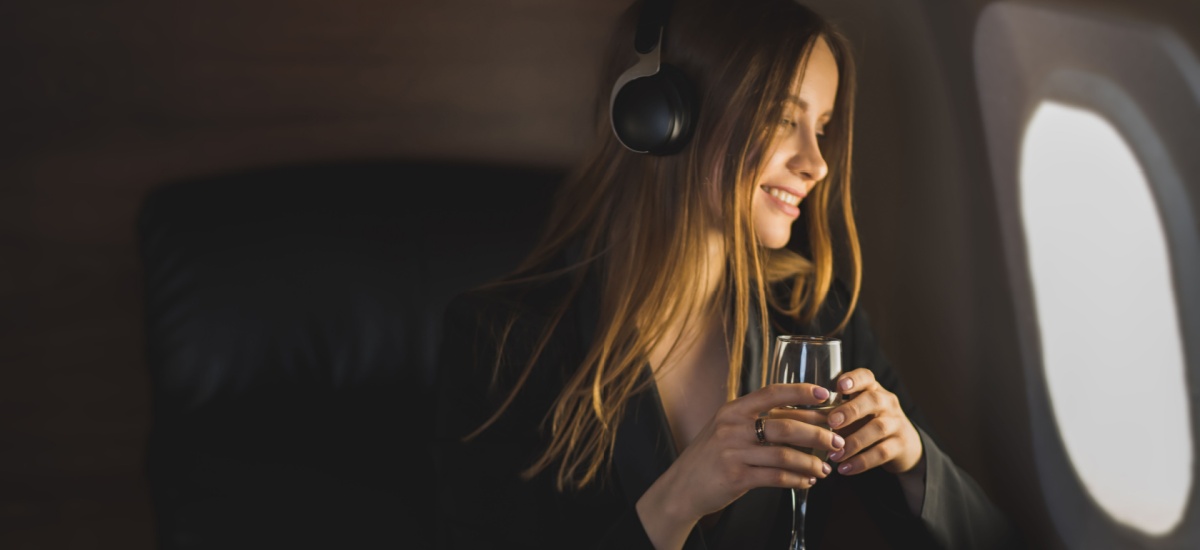 woman-on-airplane-enjoying-drink