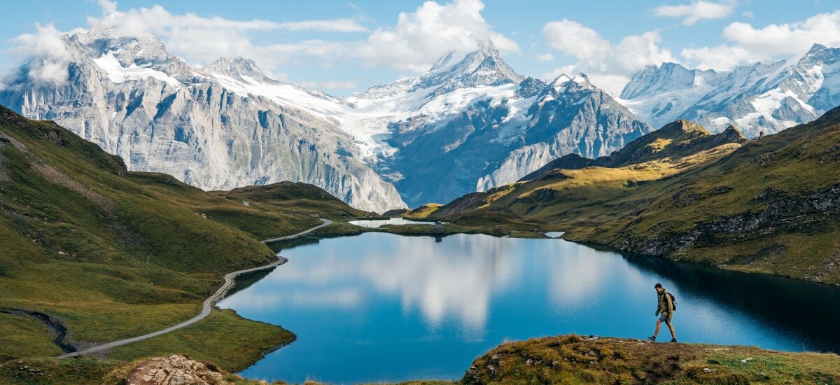 hiker-with-lake-and-swiss-mountains-on-background