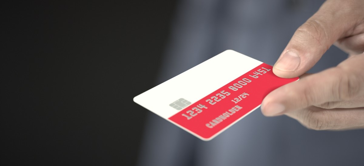 Close-up of hand holding a bankcard with a Polish flag design