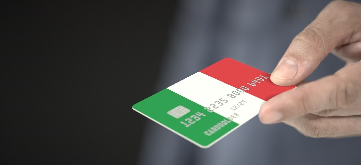 Close up of hand holding bank card with an Italian flag design