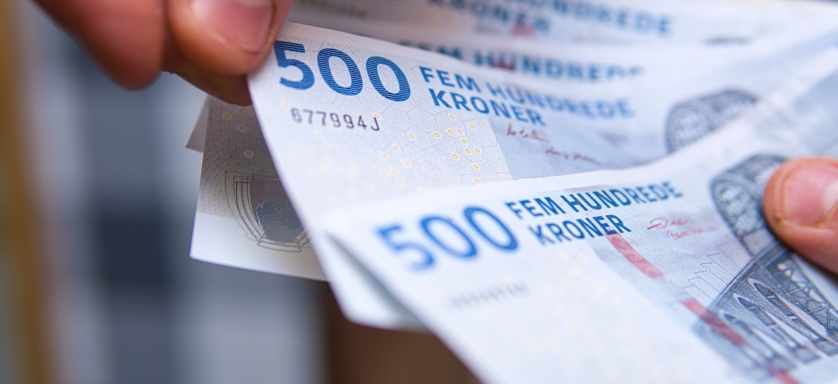 danish-krone-bank-notes-in-hand