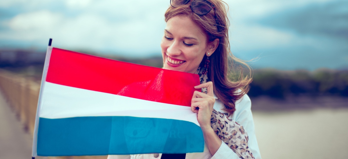 happy-young-woman-holding-a-dutch-flag