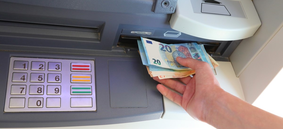 Close up of Euros being withdrawn from ATM