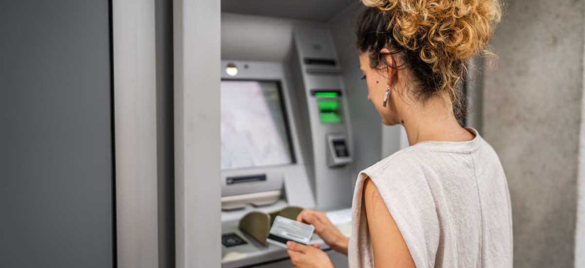 Woman using ATM with card