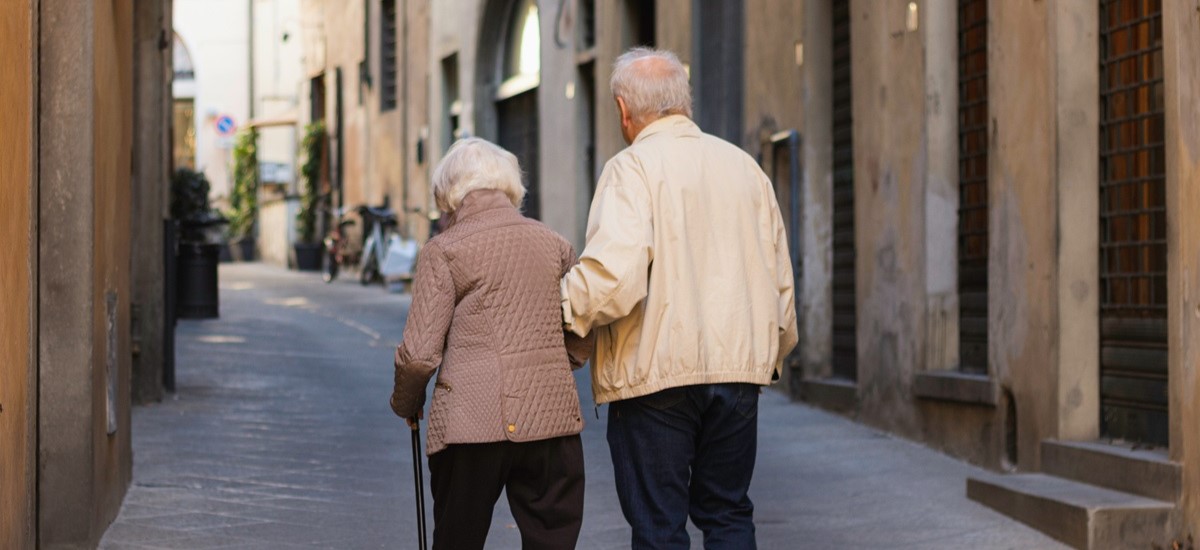 Elderly couple walking on Spanish street