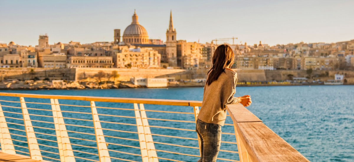 woman-looking-over-water-at-cityscape-in-malta