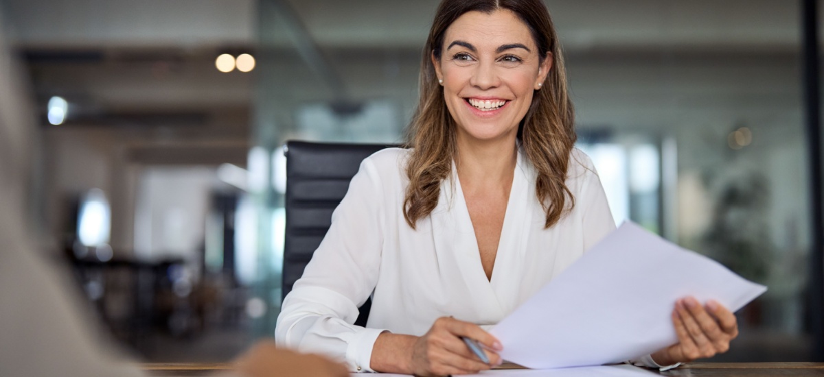 smiling-woman-holding-documents