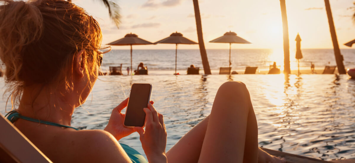 woman-using-phone-on-beach
