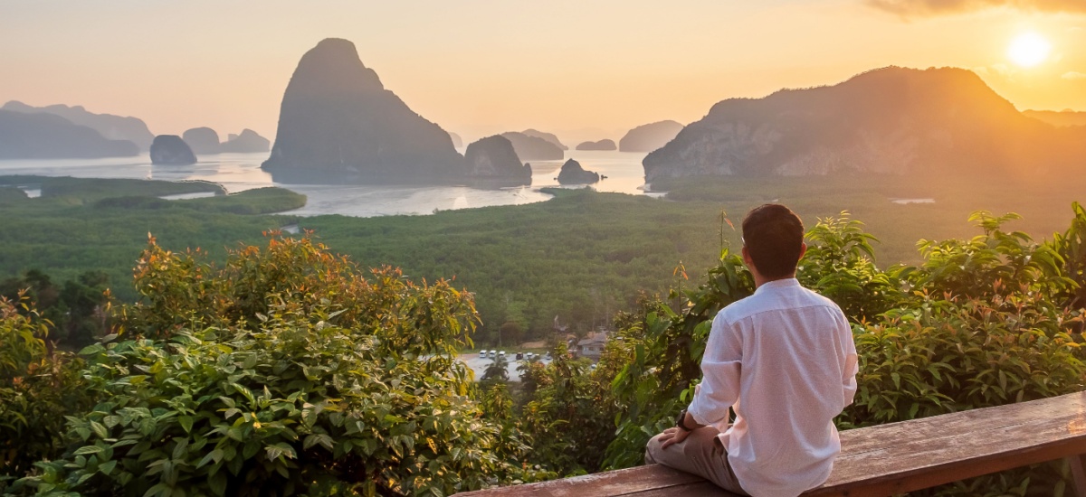 traveller-sitting-and-looking-at-sunset-and-landscape-phuket-thailand