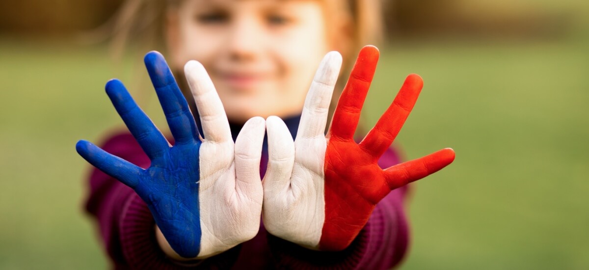 child-with-painted-hands-in-french-flag