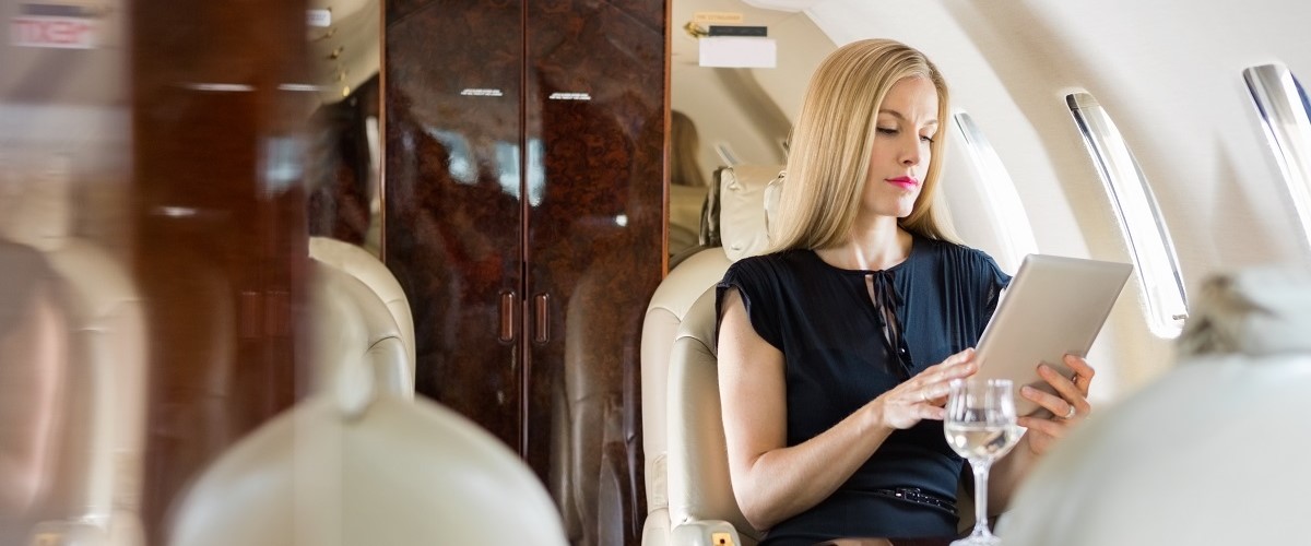 A blonde woman on a first class flight