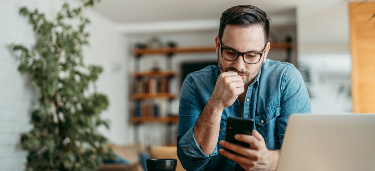 man-sitting-behind-table-looking-notes