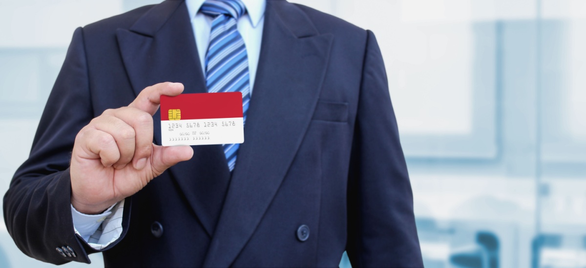 businessman-holding-monaco-credit-card