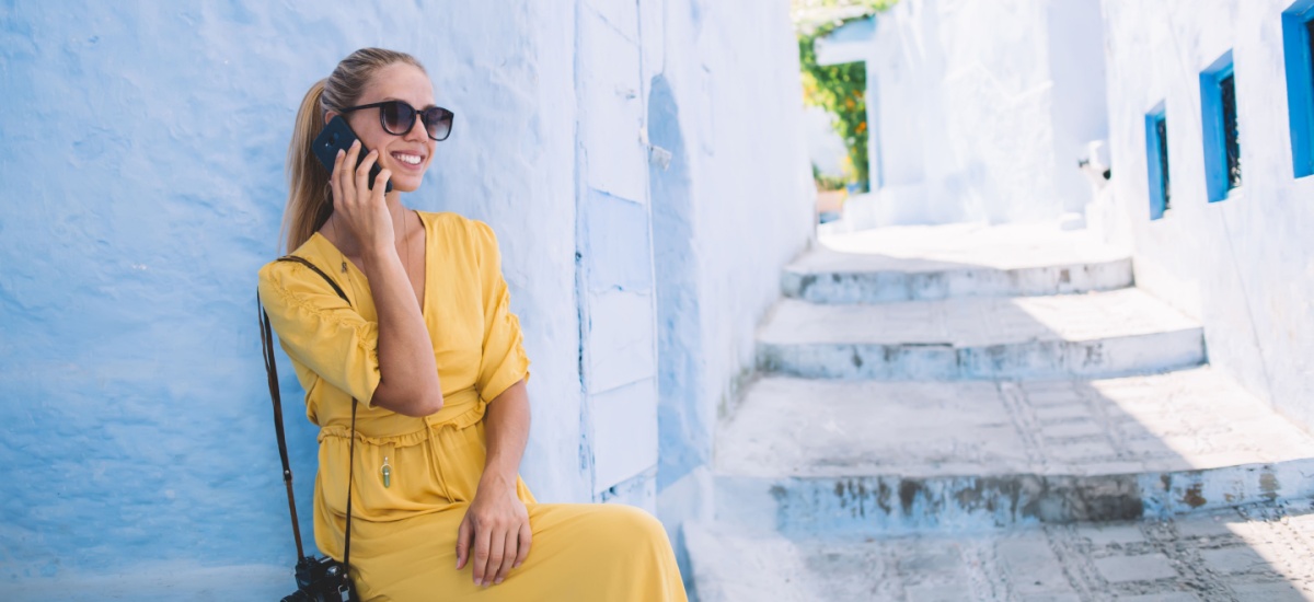 woman-sitting-and-talking-on-phone-at-moroccan-street