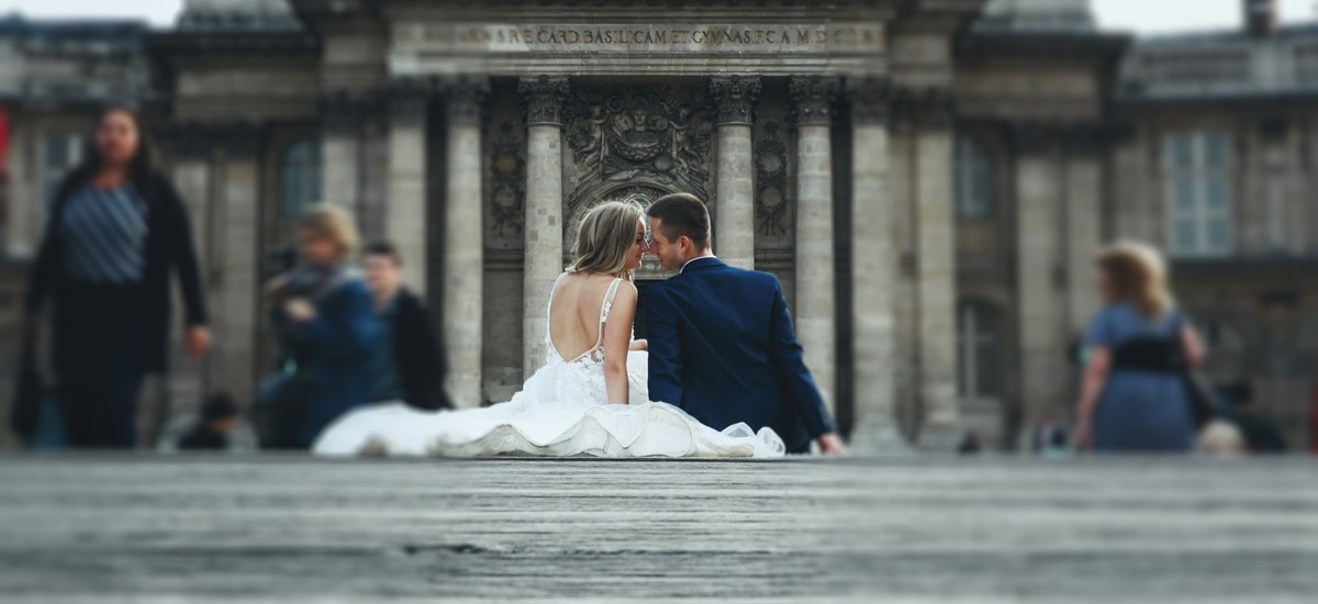 married couple sitting outside on steps of French cathedral