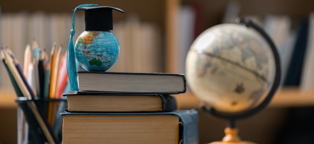 globe-with-a-graduation-hat-on-books