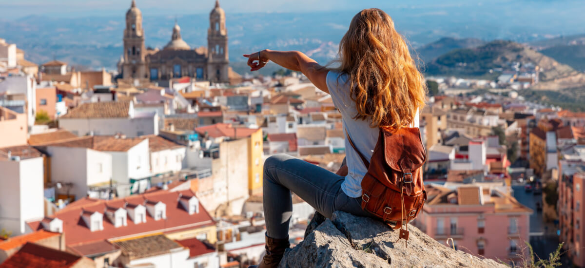 redhead-woman-tourist-sitting-looking-at-cathedral-andalusia-spain