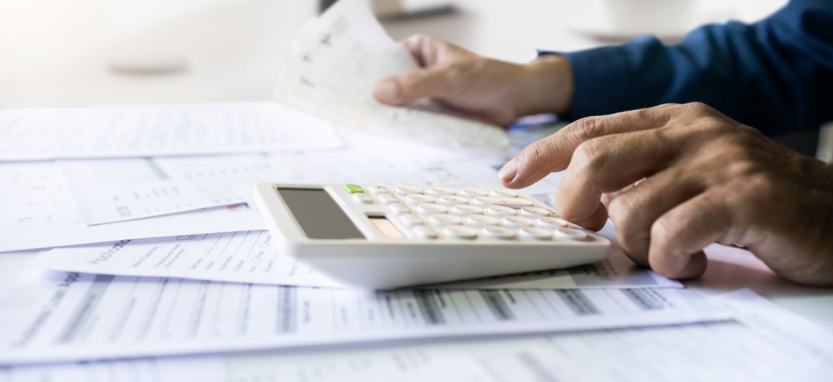 documents-scattered-on-table-with-calculator-on-top