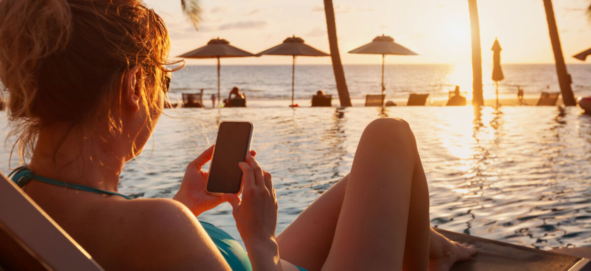 woman-using-smartphone-on-beach
