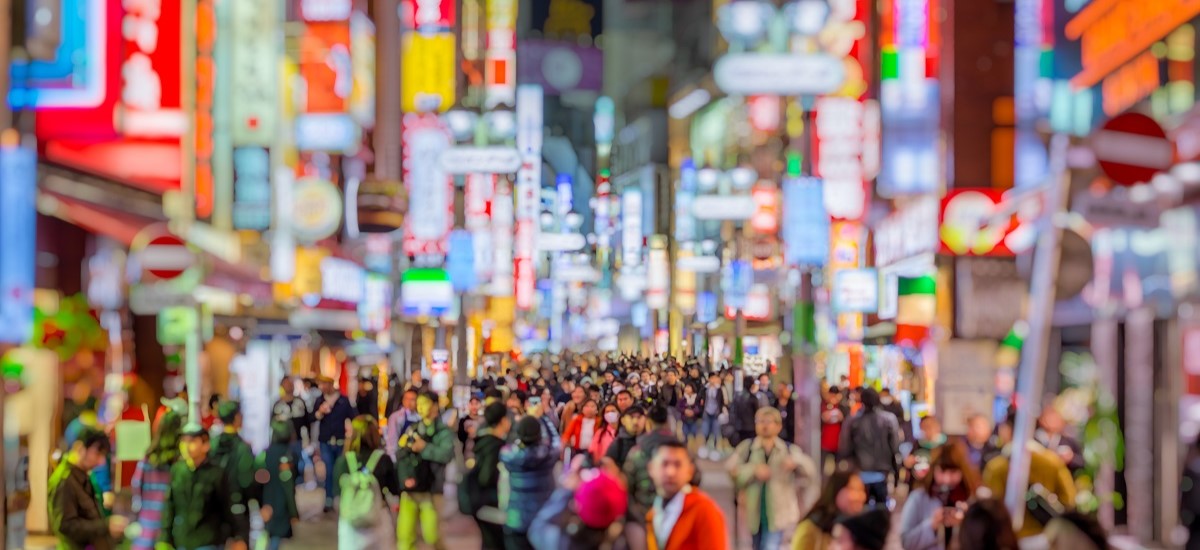 Japan street at night, blurred faces and colourful lights