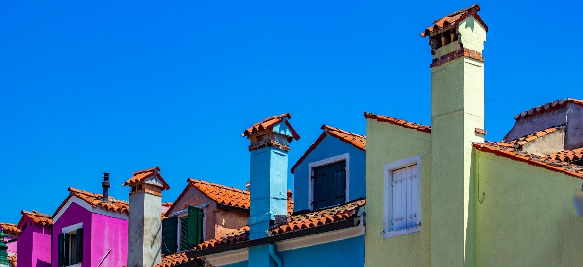 Colourful rooftops against a blue sky