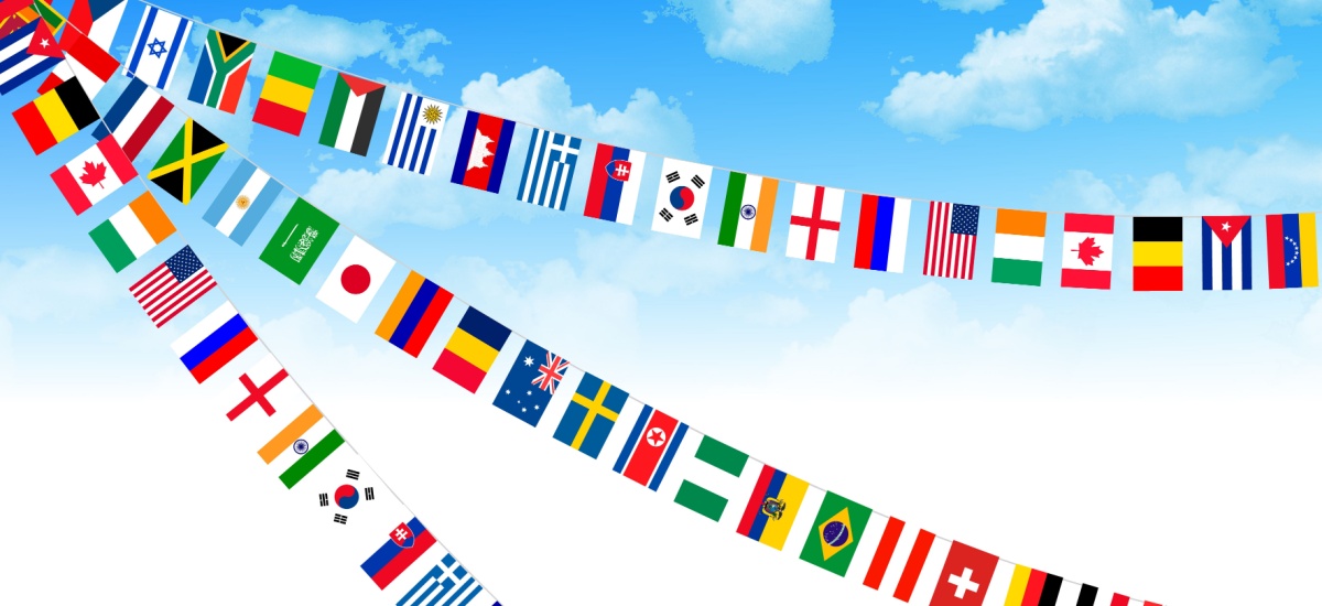 Flags around the world with blue sky in the background