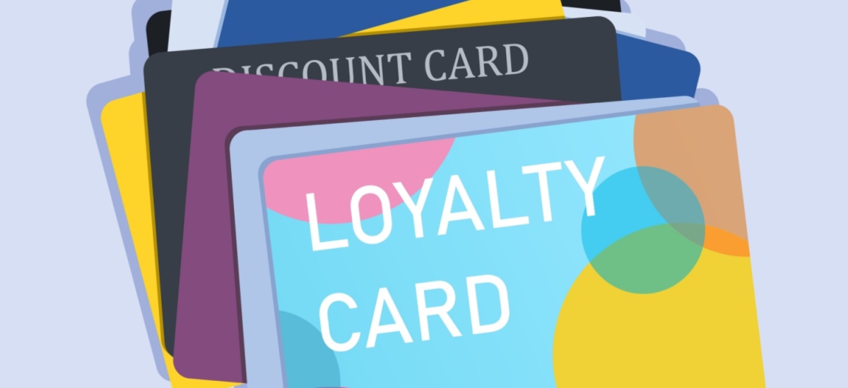 Vector image of a pile of loyalty cards in multiple colours on a lilac background