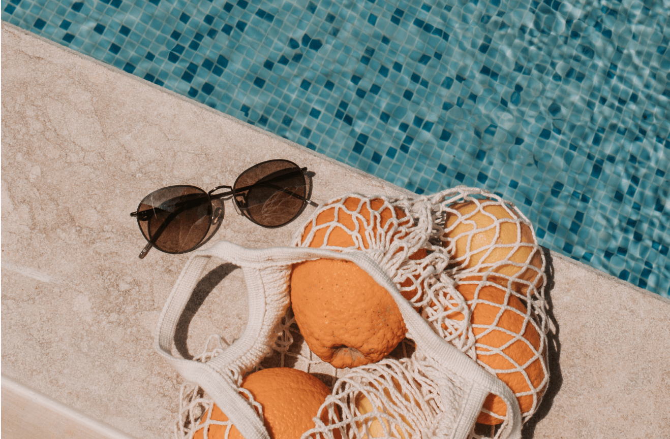 Sunglasses, swimming pool, bag of oranges