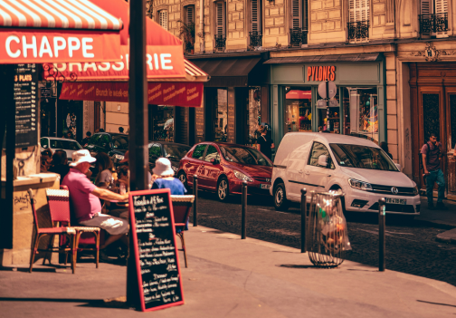 A corner restaurant in Paris and a red athletics track.