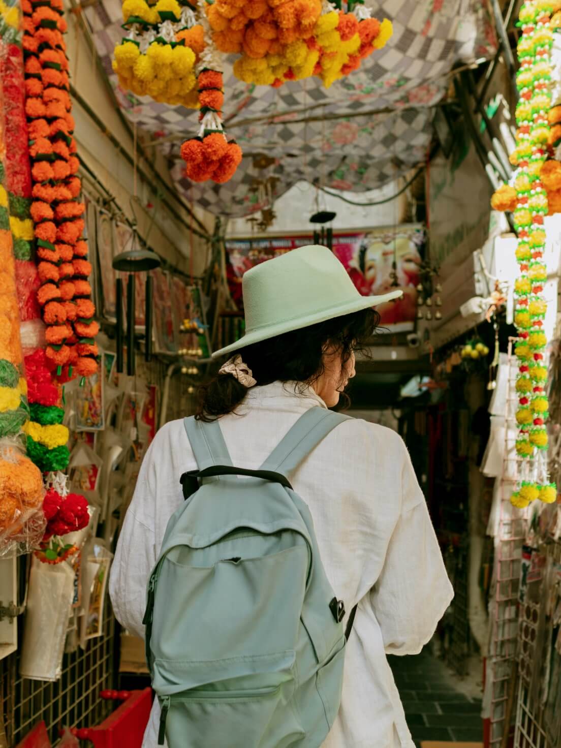 A traveller walking in a local market using a travel money card 