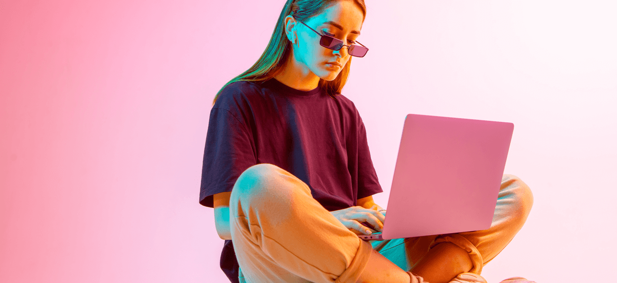 girl-with-laptop-pink-background