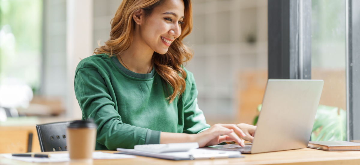 Person writing invoice on laptop