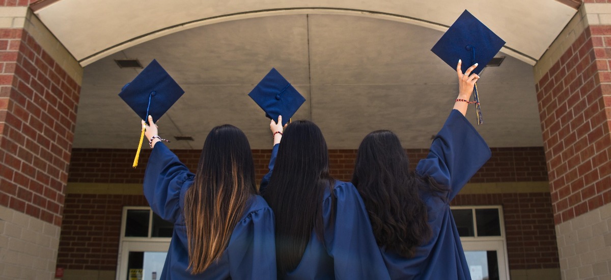 three-girls-holding-graduation-cap